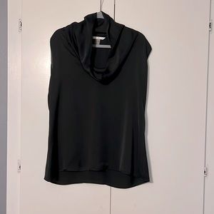 Dramatic and light funnel neck black sleeveless top
